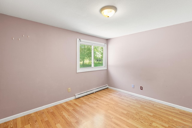 201 Baxter Rd Apt D, Mansfield, CT 06268 - spare room with baseboard heating, light wood-style flooring, and baseboards