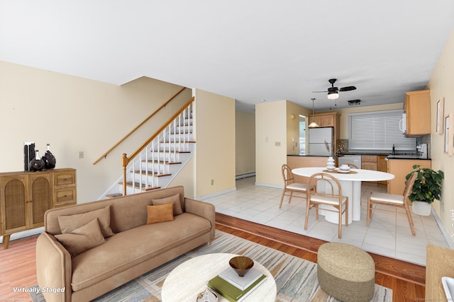 201 Baxter Rd Apt D, Mansfield, CT 06268 - living area with light wood-style floors, stairway, a ceiling fan, and baseboards