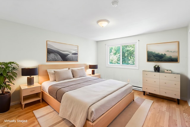 201 Baxter Rd Apt D, Mansfield, CT 06268 - bedroom with a baseboard heating unit and light wood-style flooring