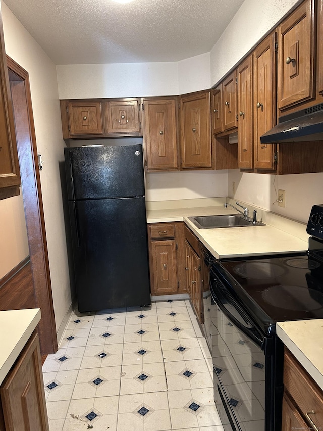 376 Cypress Rd Unit 376, Newington, CT 06111 - kitchen with black appliances, under cabinet range hood, light countertops, a textured ceiling, and light tile patterned flooring