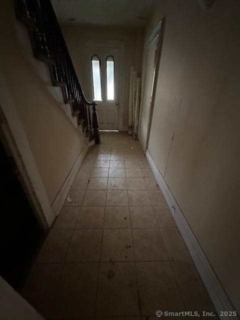 29 Division St, Norwich, CT 06360 - hall with tile patterned floors and stairs