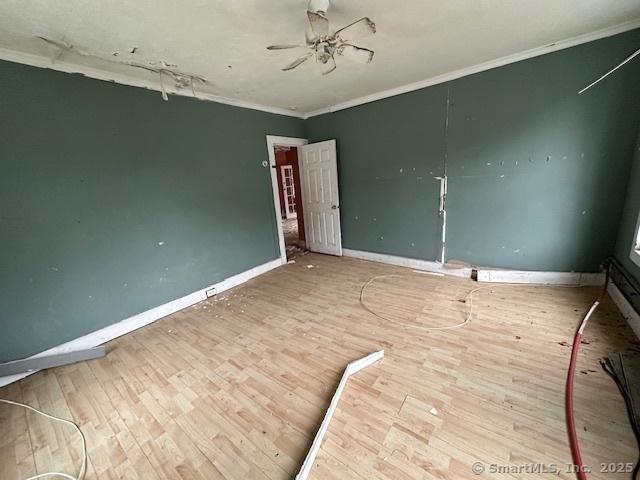 29 Division St, Norwich, CT 06360 - empty room featuring ornamental molding, wood finished floors, and ceiling fan