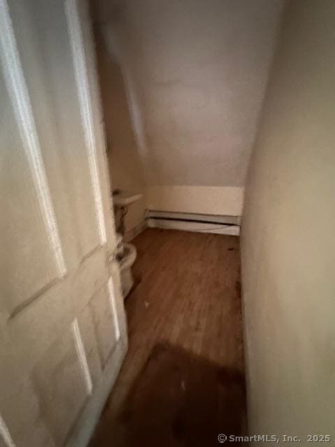 29 Division St, Norwich, CT 06360 - staircase featuring wood finished floors and a baseboard heating unit