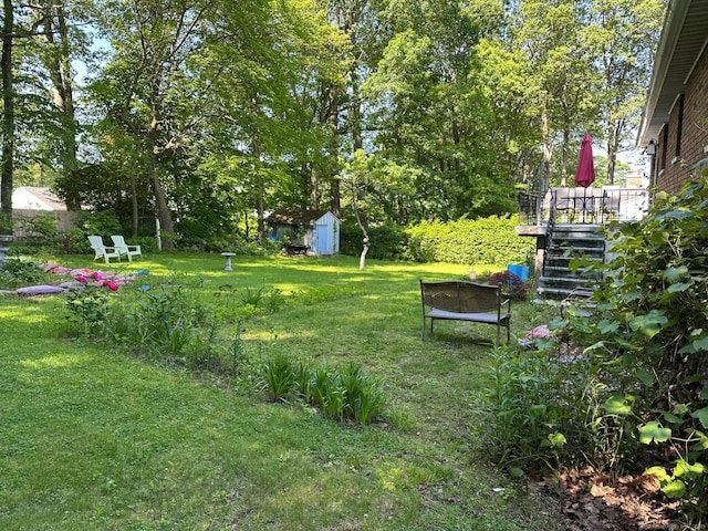 view of grassy yard featuring stairway