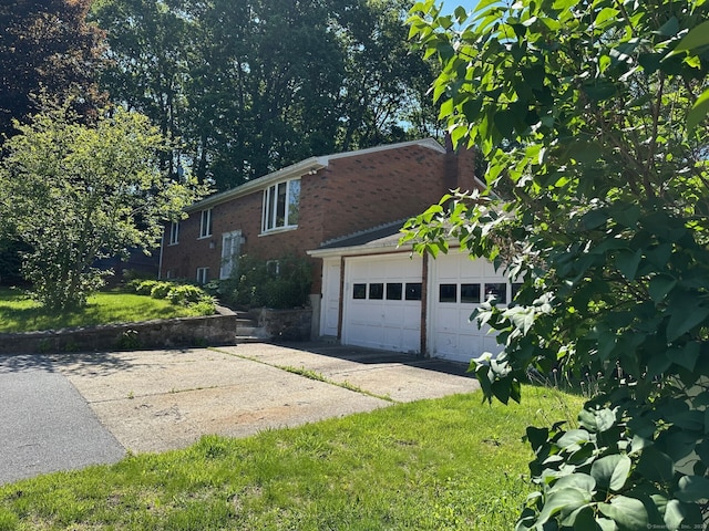 view of side of home featuring brick siding and a garage
