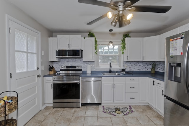 309 S Elm St, Windsor Locks, CT 06096 - kitchen with appliances with stainless steel finishes, a sink, dark countertops, and decorative backsplash