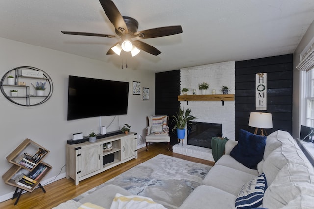 309 S Elm St, Windsor Locks, CT 06096 - living area with a ceiling fan, wood finished floors, a brick fireplace, and baseboards