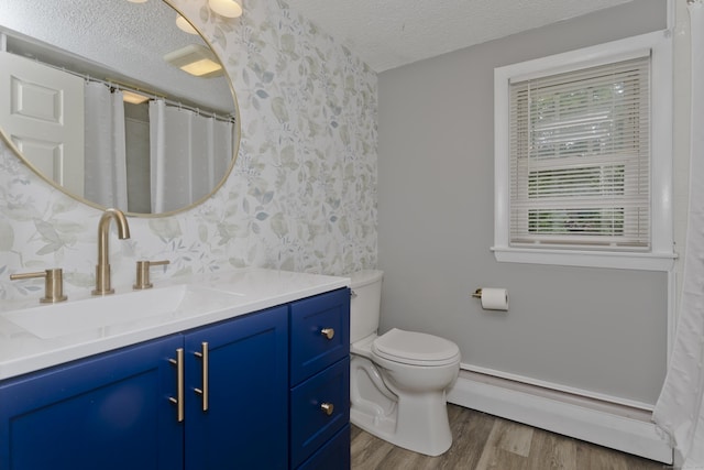 309 S Elm St, Windsor Locks, CT 06096 - bathroom featuring baseboard heating, a textured ceiling, vanity, wood finished floors, and wallpapered walls