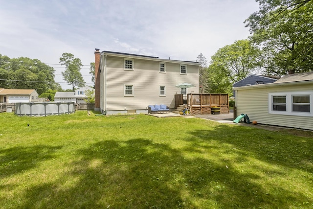 309 S Elm St, Windsor Locks, CT 06096 - back of house featuring a wooden deck, a lawn, and a chimney
