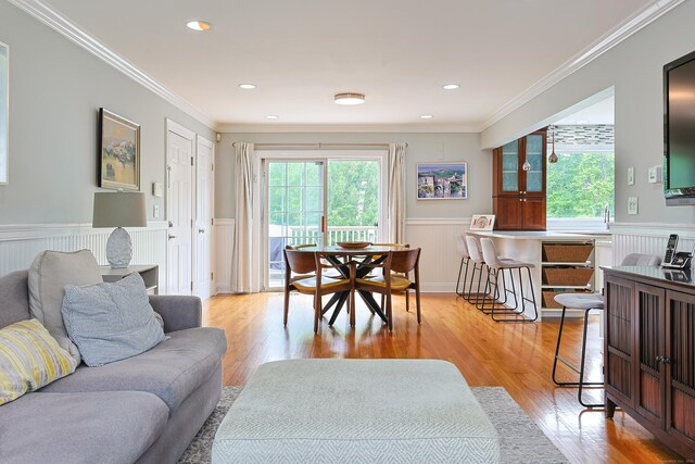402 Jones Hill Rd, West Haven, CT 06516 - living room with a wainscoted wall, light wood-style flooring, ornamental molding, and recessed lighting