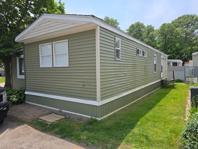 1290 N Rd Unit 15, Groton, CT 06340 - view of side of property featuring a lawn