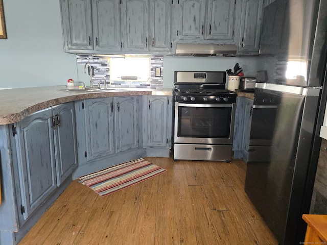 1290 N Rd Unit 15, Groton, CT 06340 - kitchen featuring appliances with stainless steel finishes, ventilation hood, light wood-type flooring, and a sink