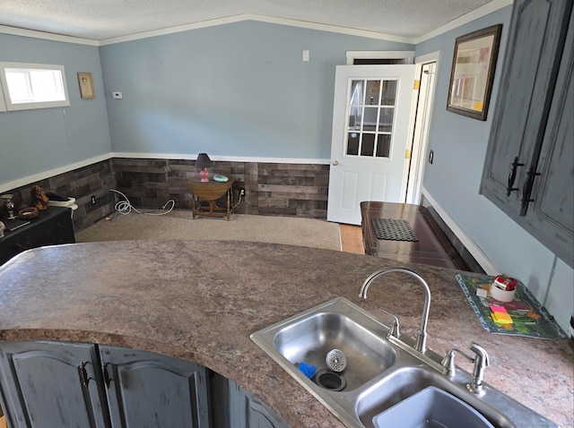 1290 N Rd Unit 15, Groton, CT 06340 - kitchen featuring a sink, wainscoting, crown molding, and a textured ceiling
