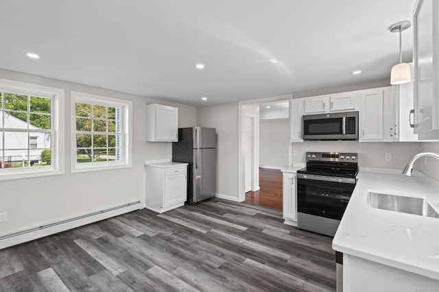 8 Wilson Ave, Waterford, CT 06375 - kitchen featuring stainless steel appliances, a sink, a baseboard radiator, light countertops, and white cabinetry