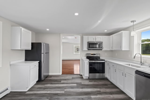 8 Wilson Ave, Waterford, CT 06375 - kitchen with stainless steel appliances, a sink, a baseboard radiator, white cabinets, and recessed lighting
