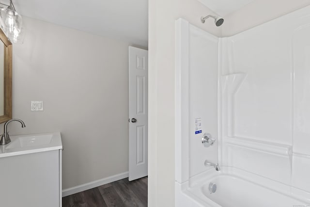 8 Wilson Ave, Waterford, CT 06375 - bathroom with bathtub / shower combination, vanity, wood finished floors, and baseboards