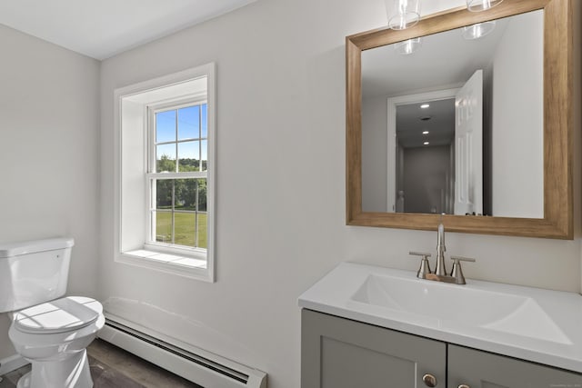 8 Wilson Ave, Waterford, CT 06375 - bathroom with a baseboard heating unit, toilet, vanity, and wood finished floors