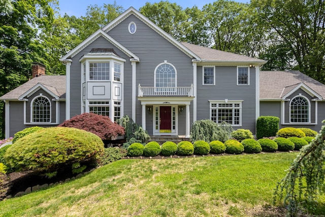 35 Hunting Ridge Rd, Easton, CT 06612 - view of front of home with a balcony, a front lawn, and a shingled roof