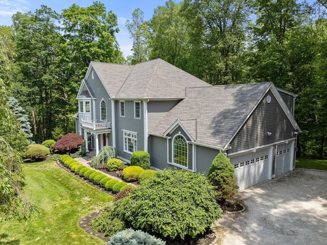 35 Hunting Ridge Rd, Easton, CT 06612 - view of front facade with a balcony, a shingled roof, driveway, a front lawn, and a garage