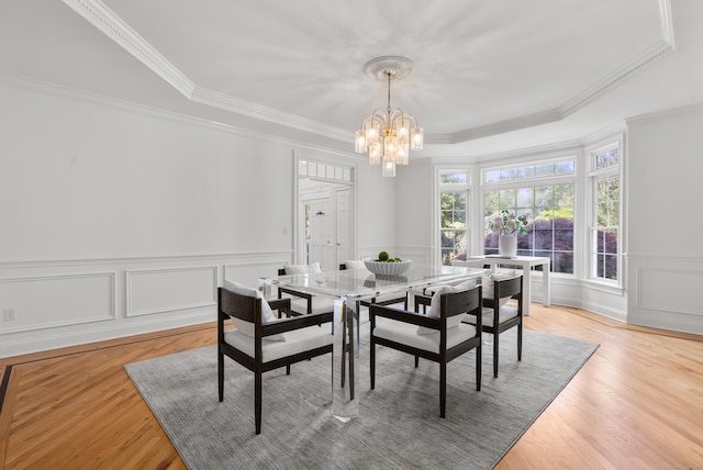 35 Hunting Ridge Rd, Easton, CT 06612 - dining room featuring a chandelier, crown molding, a raised ceiling, light wood-style flooring, and a decorative wall