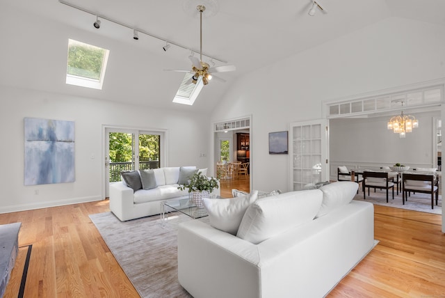 35 Hunting Ridge Rd, Easton, CT 06612 - living room with rail lighting, high vaulted ceiling, a ceiling fan, a skylight, and light wood-style flooring