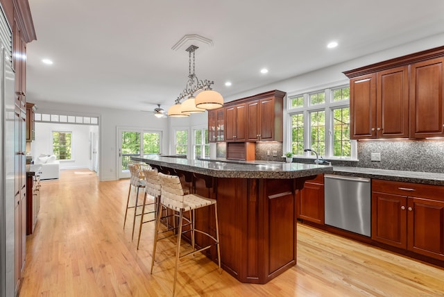35 Hunting Ridge Rd, Easton, CT 06612 - kitchen featuring stainless steel dishwasher, a kitchen breakfast bar, light wood-type flooring, backsplash, and recessed lighting