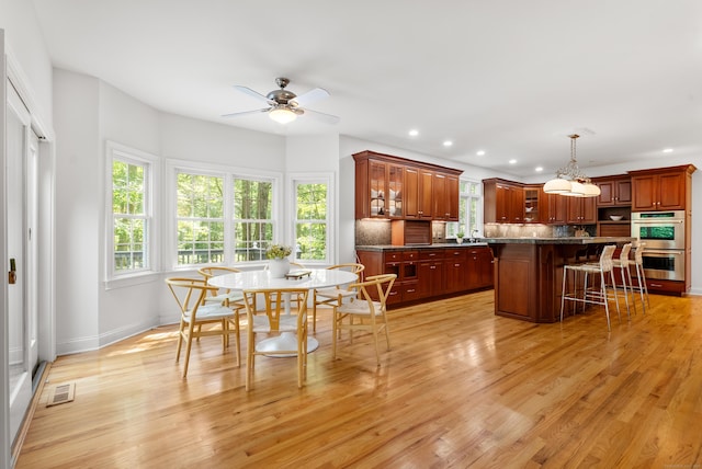 35 Hunting Ridge Rd, Easton, CT 06612 - kitchen with stainless steel double oven, a breakfast bar area, ceiling fan, recessed lighting, and decorative backsplash