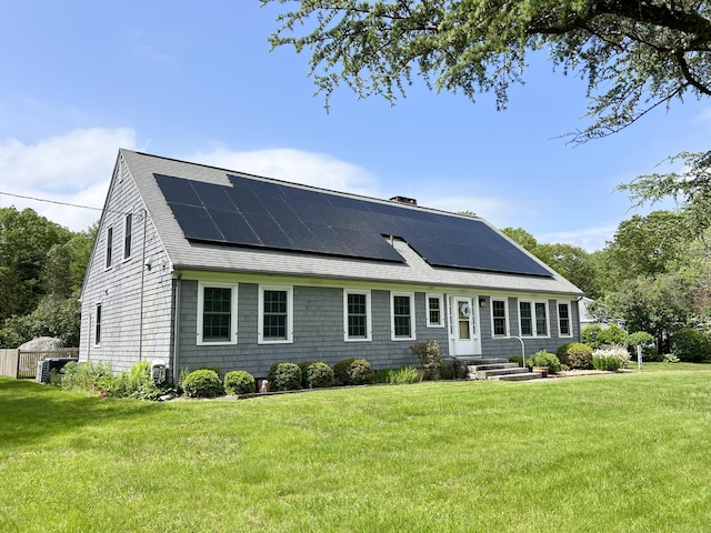 104 Quaker Farm Rd, Groton, CT 06355 - view of front of house featuring roof with shingles, solar panels, and a front yard