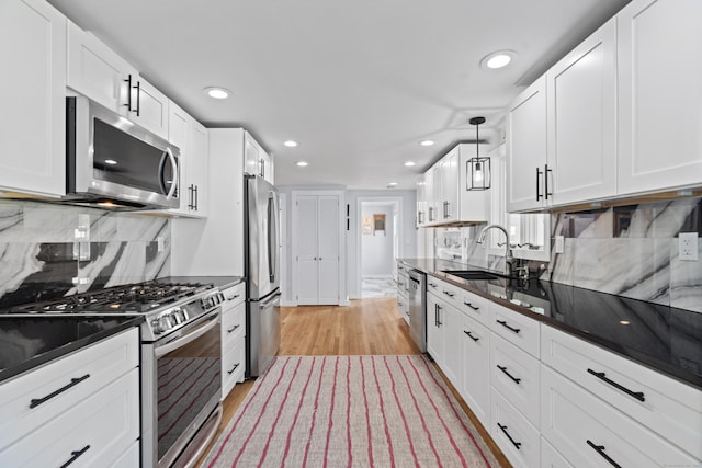 104 Quaker Farm Rd, Groton, CT 06355 - kitchen featuring appliances with stainless steel finishes, a sink, dark countertops, recessed lighting, and white cabinetry