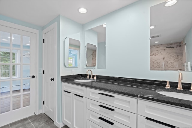 104 Quaker Farm Rd, Groton, CT 06355 - bathroom with double vanity, a baseboard radiator, a shower, tile patterned flooring, and recessed lighting