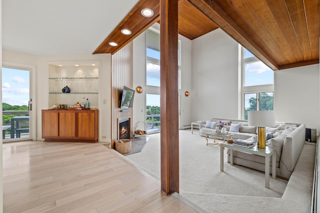 70 Prospect Hill Rd, Groton, CT 06340 - living area with light wood finished floors, a warm lit fireplace, wood ceiling, and recessed lighting