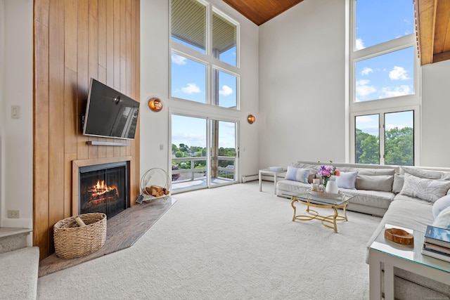 70 Prospect Hill Rd, Groton, CT 06340 - living room featuring high vaulted ceiling, a lit fireplace, and carpet flooring