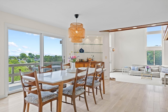 70 Prospect Hill Rd, Groton, CT 06340 - dining room with healthy amount of natural light, light wood finished floors, a baseboard radiator, bar, and recessed lighting