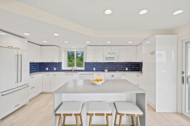 70 Prospect Hill Rd, Groton, CT 06340 - kitchen featuring white appliances, modern cabinets, a kitchen breakfast bar, light wood-style floors, and recessed lighting