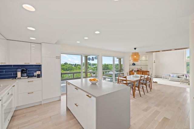70 Prospect Hill Rd, Groton, CT 06340 - kitchen with modern cabinets, light wood-style floors, white cabinets, oven, and tasteful backsplash