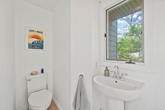 70 Prospect Hill Rd, Groton, CT 06340 - bathroom with toilet, a sink, and baseboards