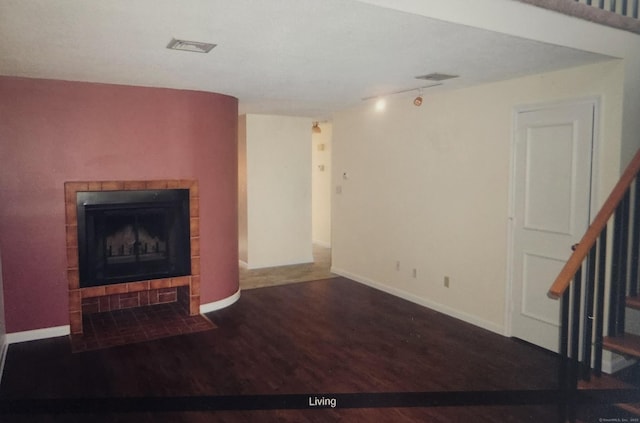 280 Brittany Farms Rd Apt C, New Britain, CT 06053 - unfurnished living room with wood finished floors, stairway, a tile fireplace, and baseboards