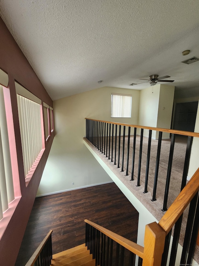 280 Brittany Farms Rd Apt C, New Britain, CT 06053 - staircase featuring lofted ceiling, wood finished floors, a ceiling fan, and a textured ceiling
