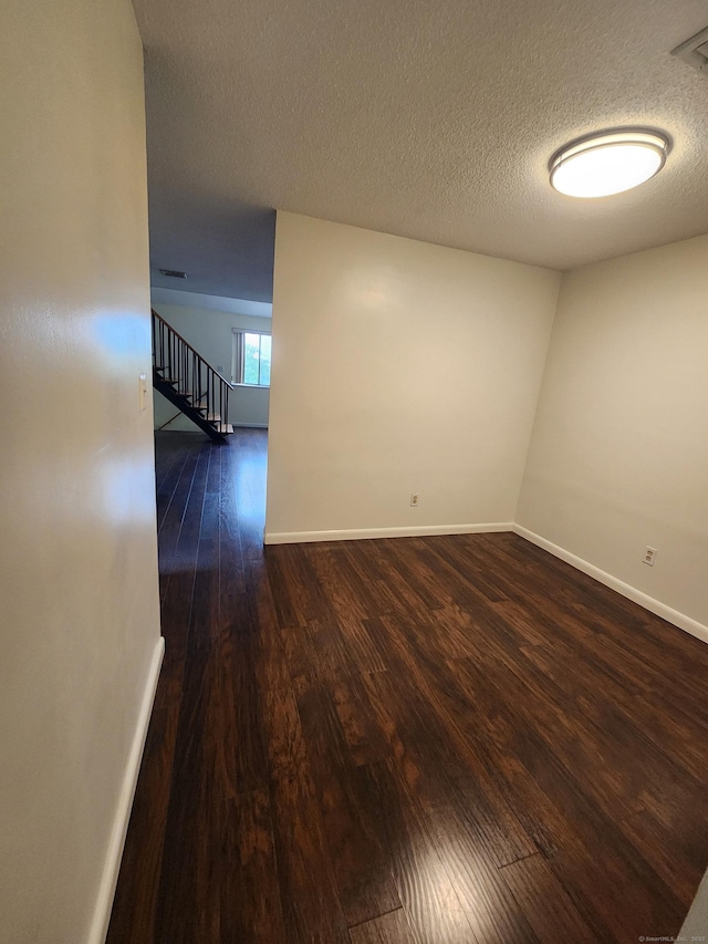 280 Brittany Farms Rd Apt C, New Britain, CT 06053 - empty room with wood-type flooring, a textured ceiling, and stairway