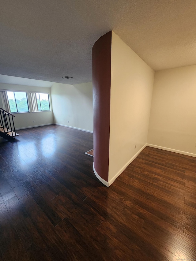 280 Brittany Farms Rd Apt C, New Britain, CT 06053 - empty room with dark wood-style flooring, a textured ceiling, and stairway