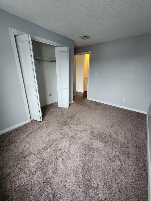 280 Brittany Farms Rd Apt C, New Britain, CT 06053 - unfurnished bedroom featuring carpet flooring, a textured ceiling, and a closet
