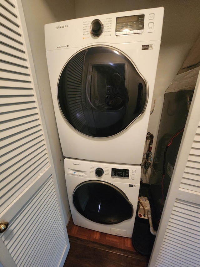 280 Brittany Farms Rd Apt C, New Britain, CT 06053 - washroom featuring stacked washer / dryer and wood finished floors