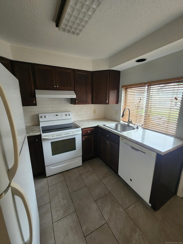 280 Brittany Farms Rd Apt C, New Britain, CT 06053 - kitchen with white appliances, under cabinet range hood, light countertops, tasteful backsplash, and dark brown cabinets