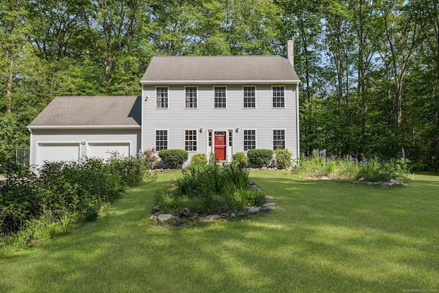 58 Snake Meadow Rd, Killingly, CT 06239 - colonial house featuring an attached garage, a front lawn, and a chimney