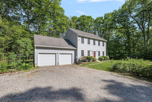 58 Snake Meadow Rd, Killingly, CT 06239 - colonial house with a garage, gravel driveway, a chimney, and a front lawn