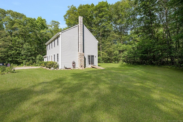 58 Snake Meadow Rd, Killingly, CT 06239 - view of side of home with a lawn and a chimney