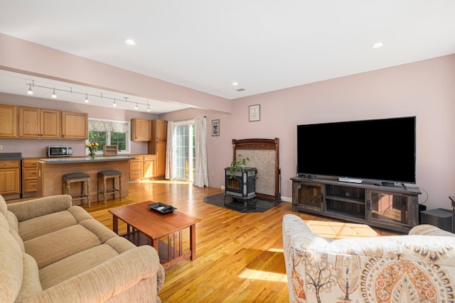 58 Snake Meadow Rd, Killingly, CT 06239 - living room featuring a wood stove, light wood-style flooring, and recessed lighting