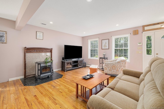58 Snake Meadow Rd, Killingly, CT 06239 - living room with light wood finished floors, a wood stove, recessed lighting, a baseboard heating unit, and baseboards