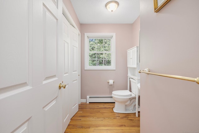 58 Snake Meadow Rd, Killingly, CT 06239 - bathroom featuring baseboard heating, toilet, wood finished floors, and baseboards