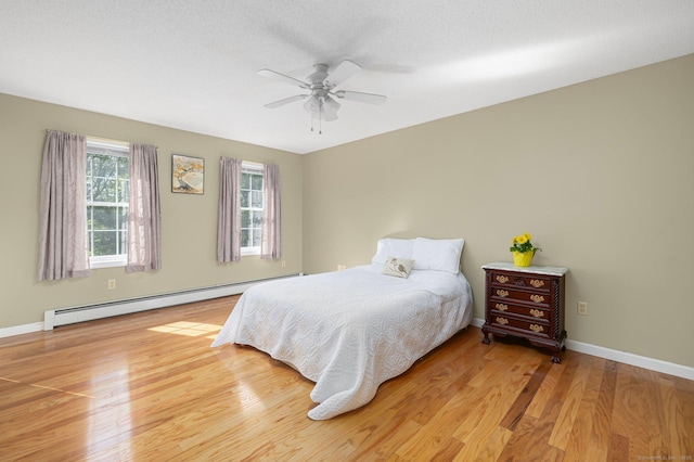 58 Snake Meadow Rd, Killingly, CT 06239 - bedroom featuring a baseboard radiator, light wood finished floors, baseboards, and ceiling fan